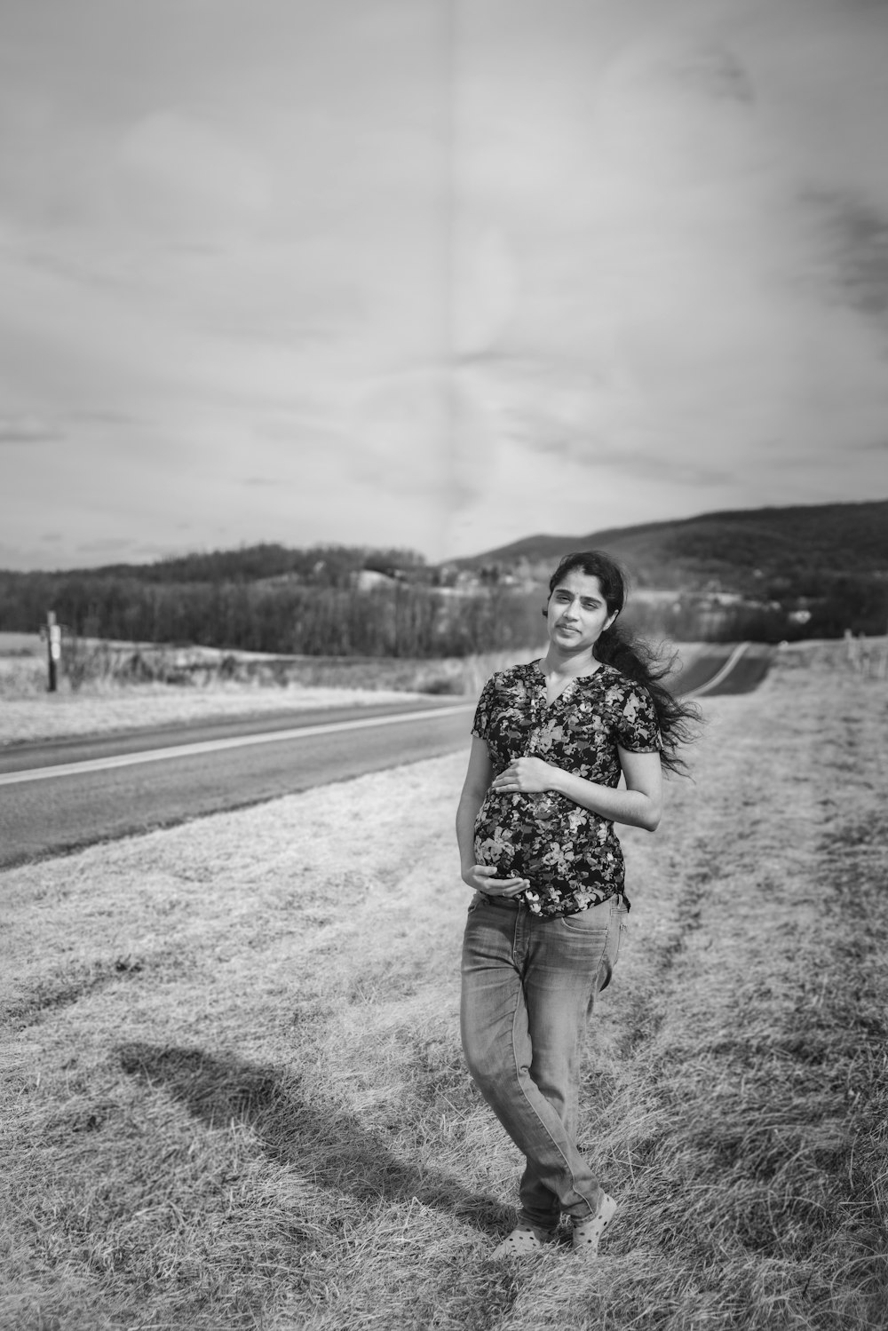 a woman standing in the middle of a field