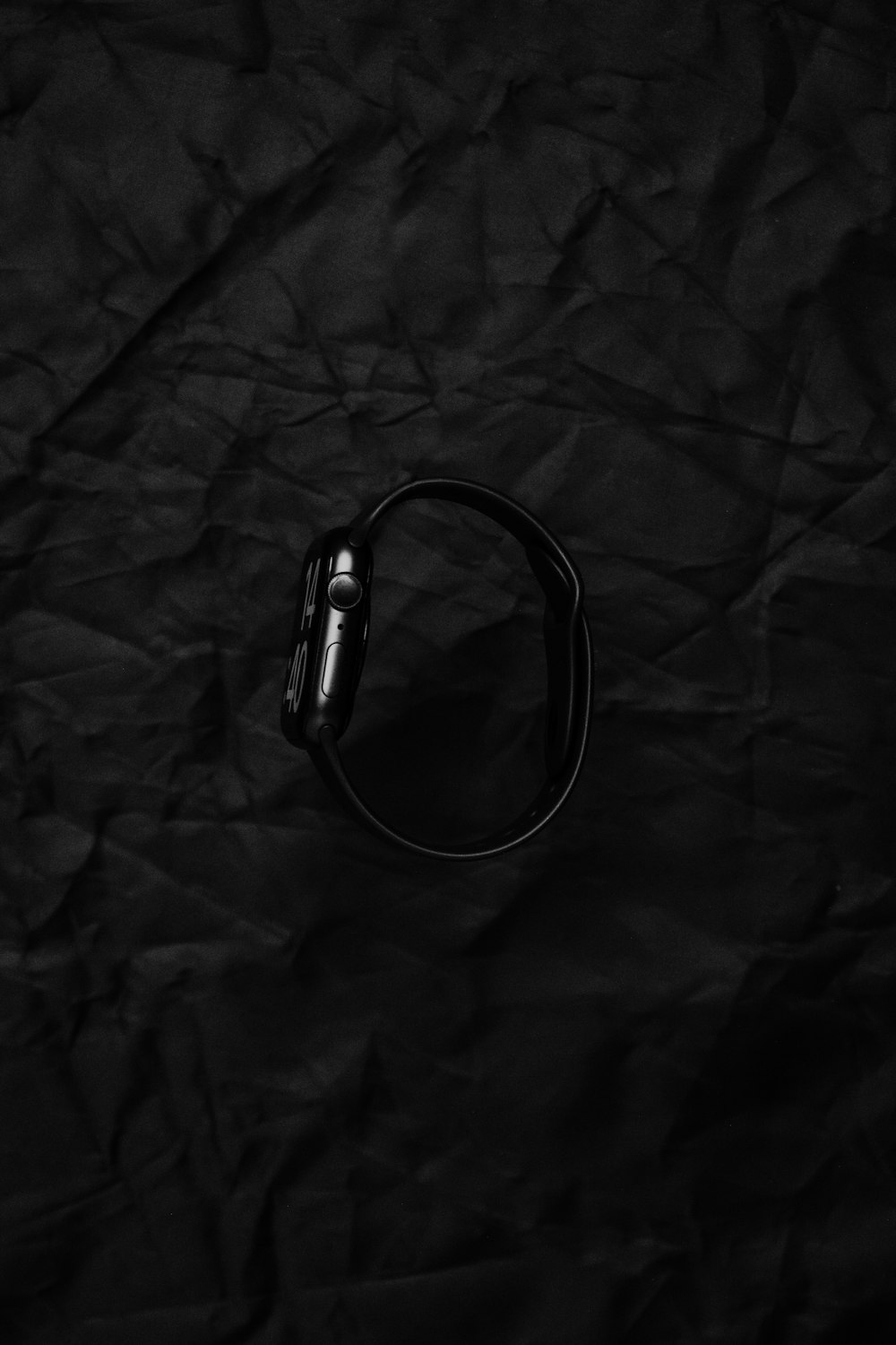 a pair of headphones sitting on top of a black piece of paper
