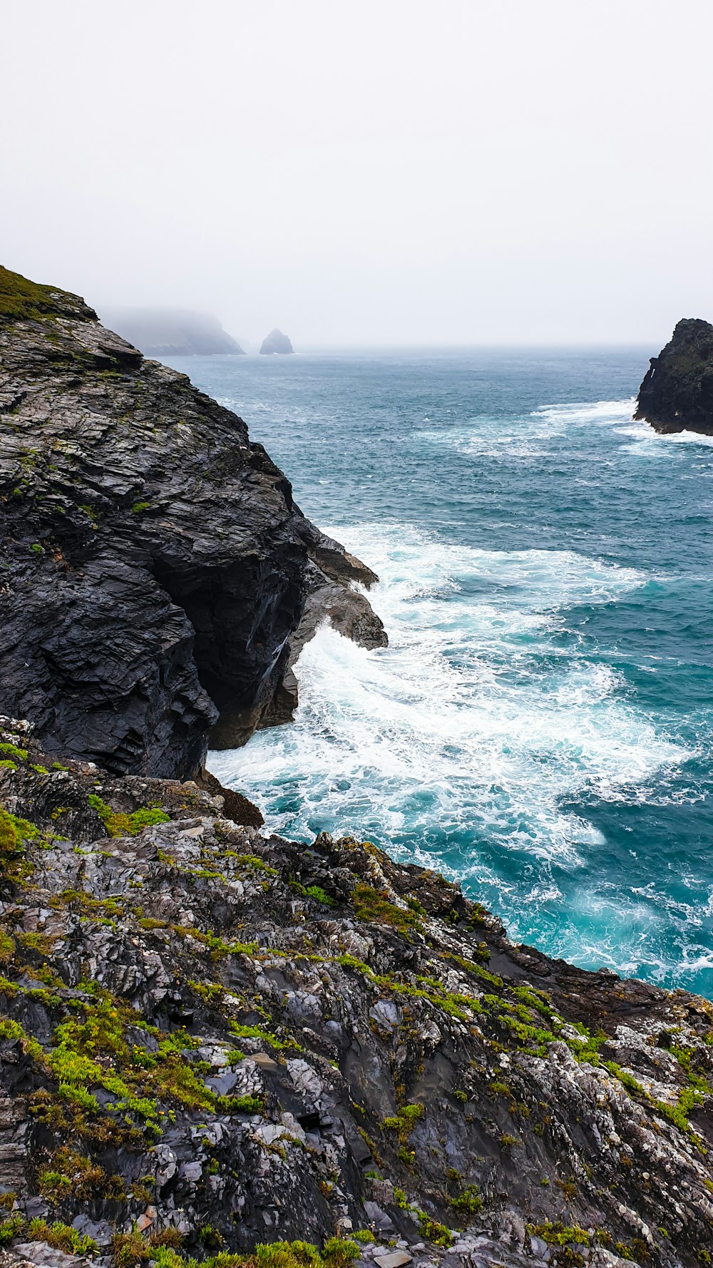 a rocky cliff overlooks a body of water