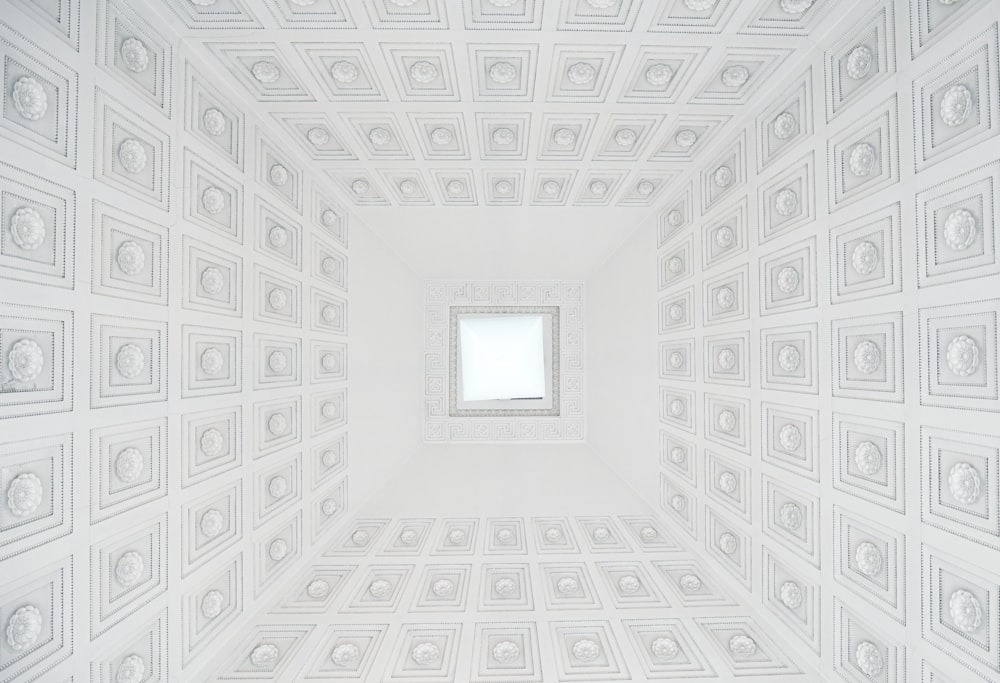 a white room with a square window in the center