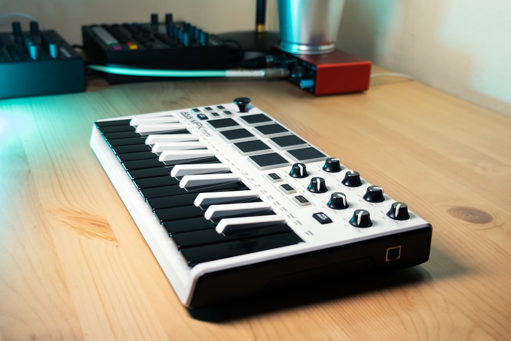 a keyboard sitting on top of a wooden table