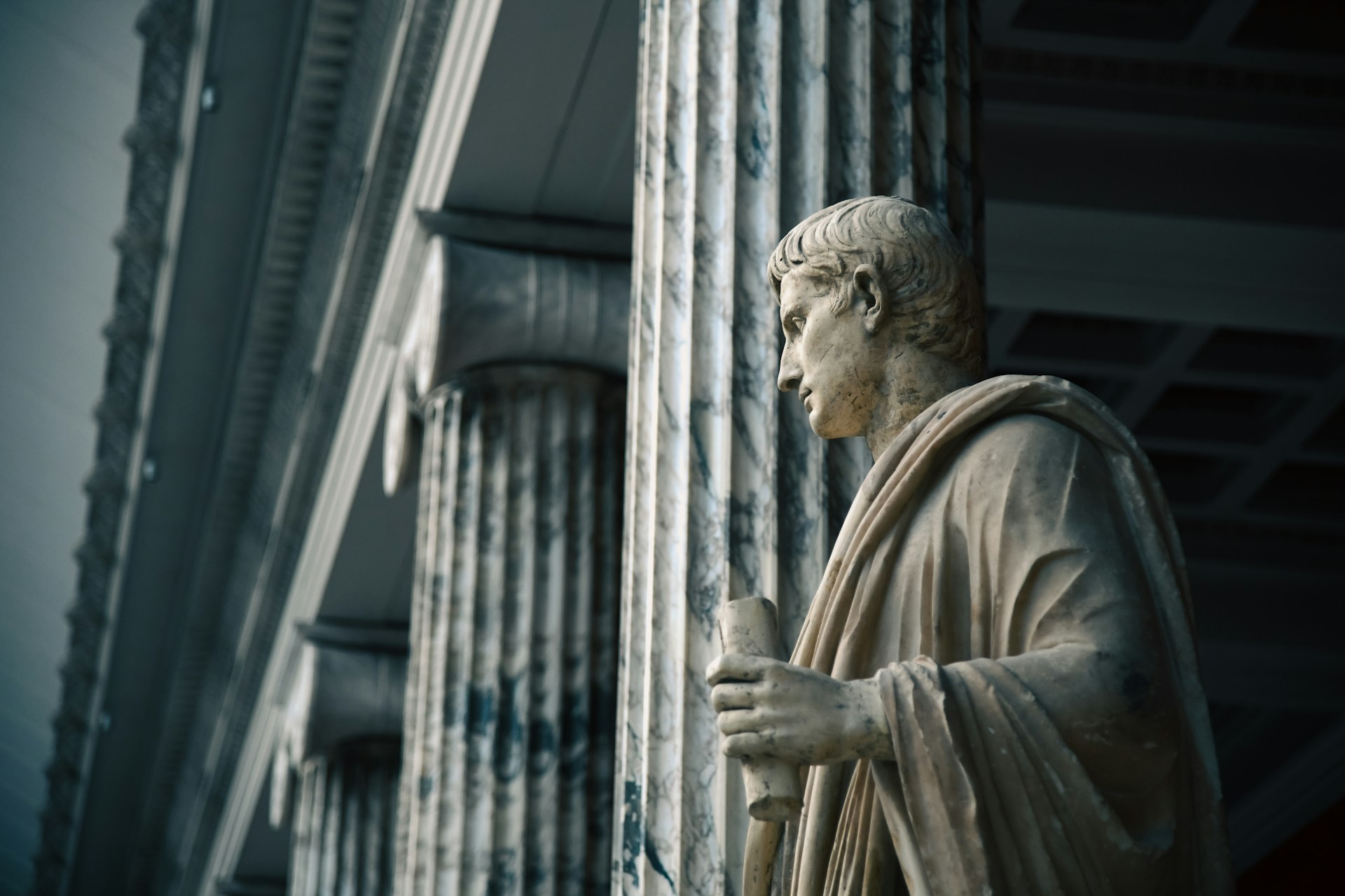 a statue of a man standing next to a building