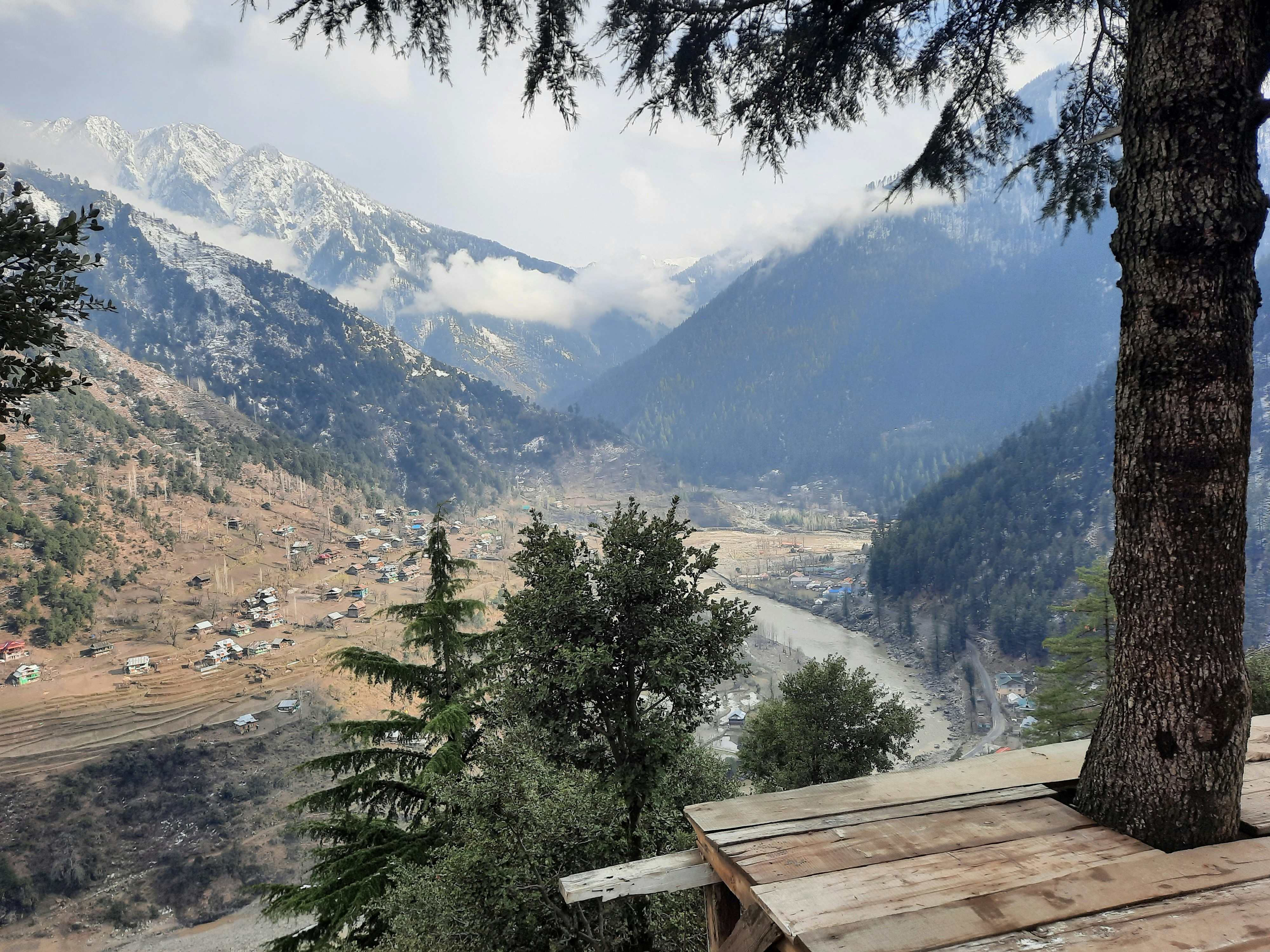 a view of a valley with mountains in the background
