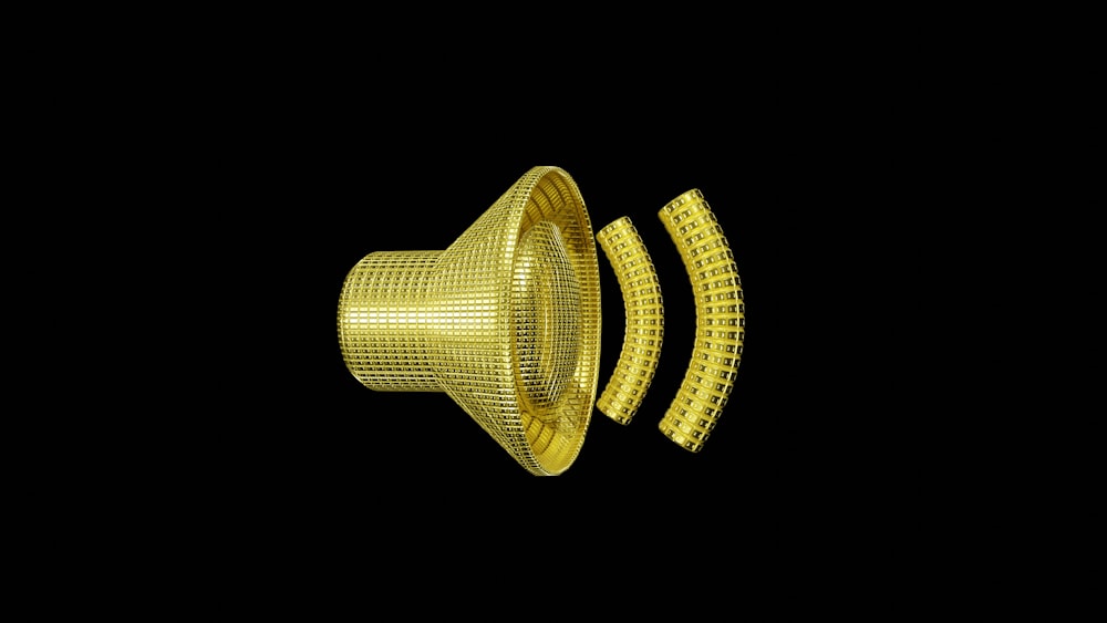 a yellow metal object with a black background