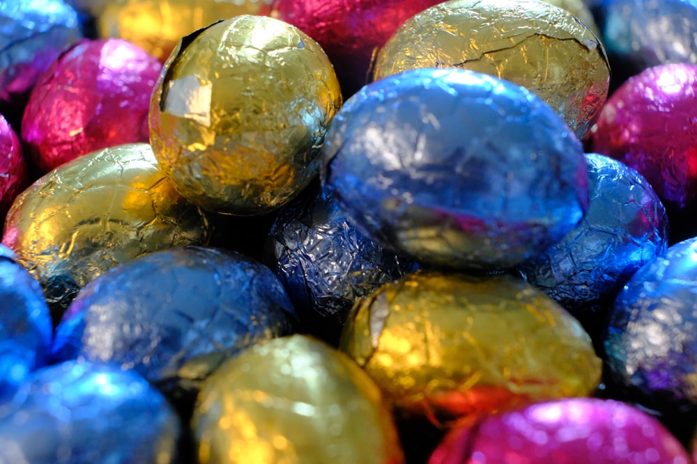 a pile of foil wrapped chocolate eggs sitting on top of each other