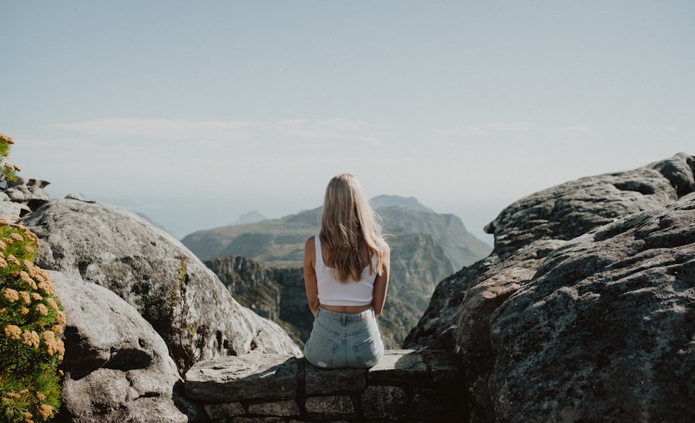 a person standing in front of a rocky mountain