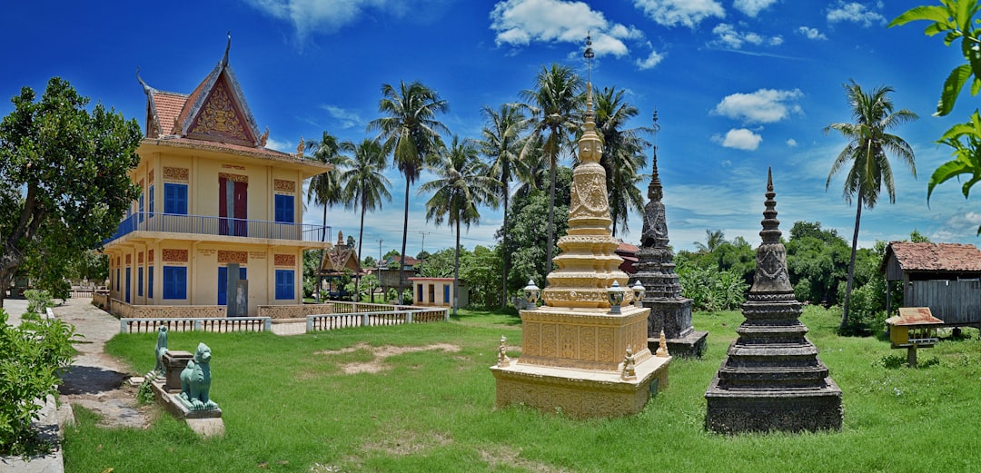 a large yellow building sitting on top of a lush green field,