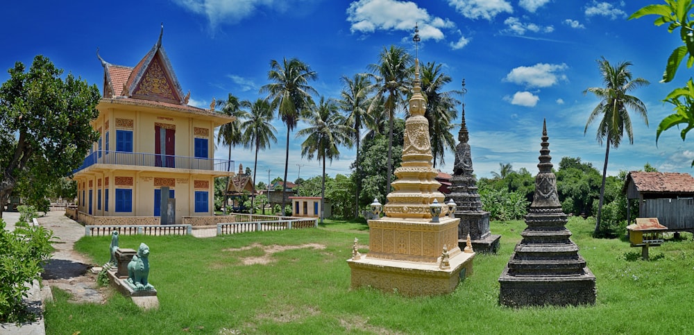 a large yellow building sitting on top of a lush green field