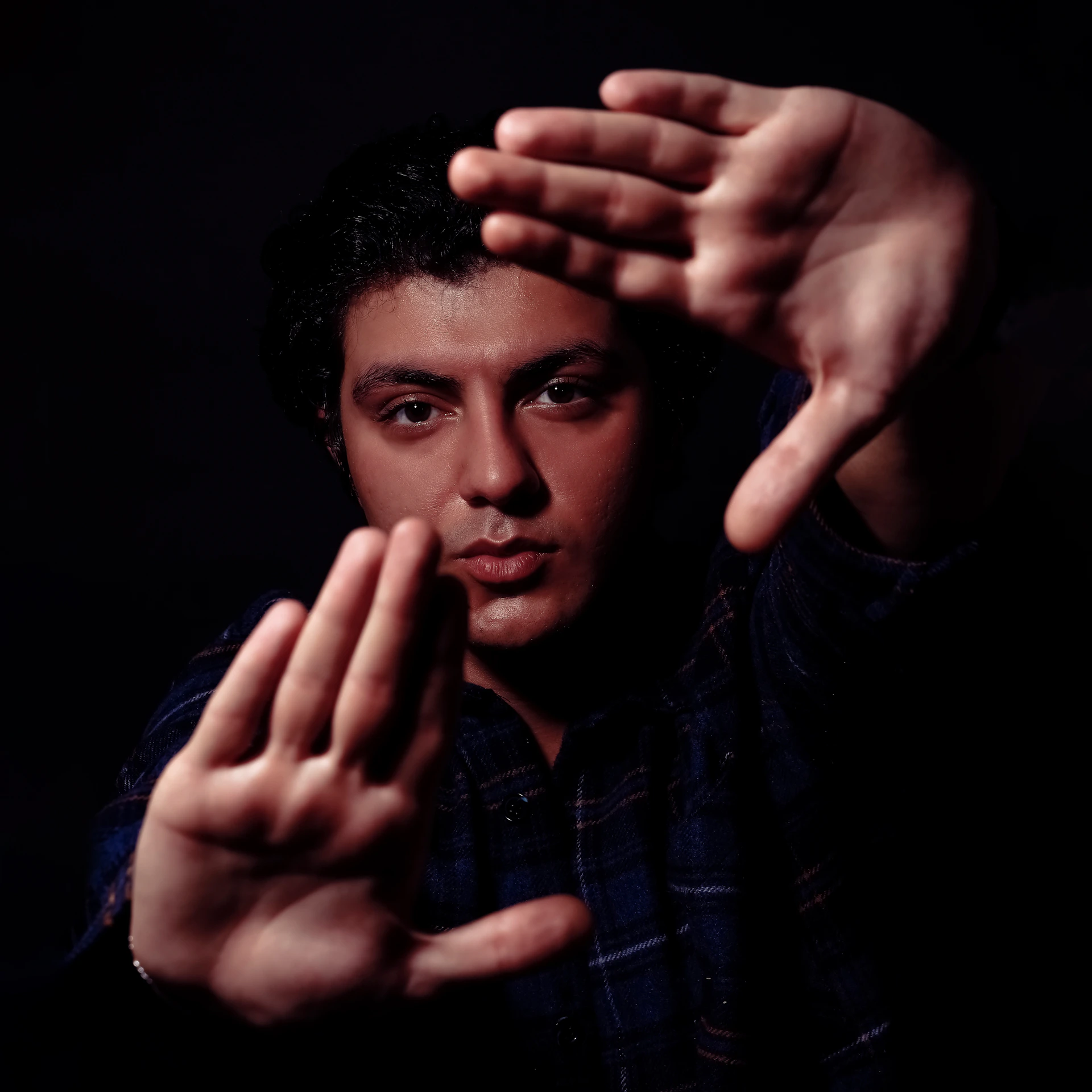 a man holding his hands up in the air