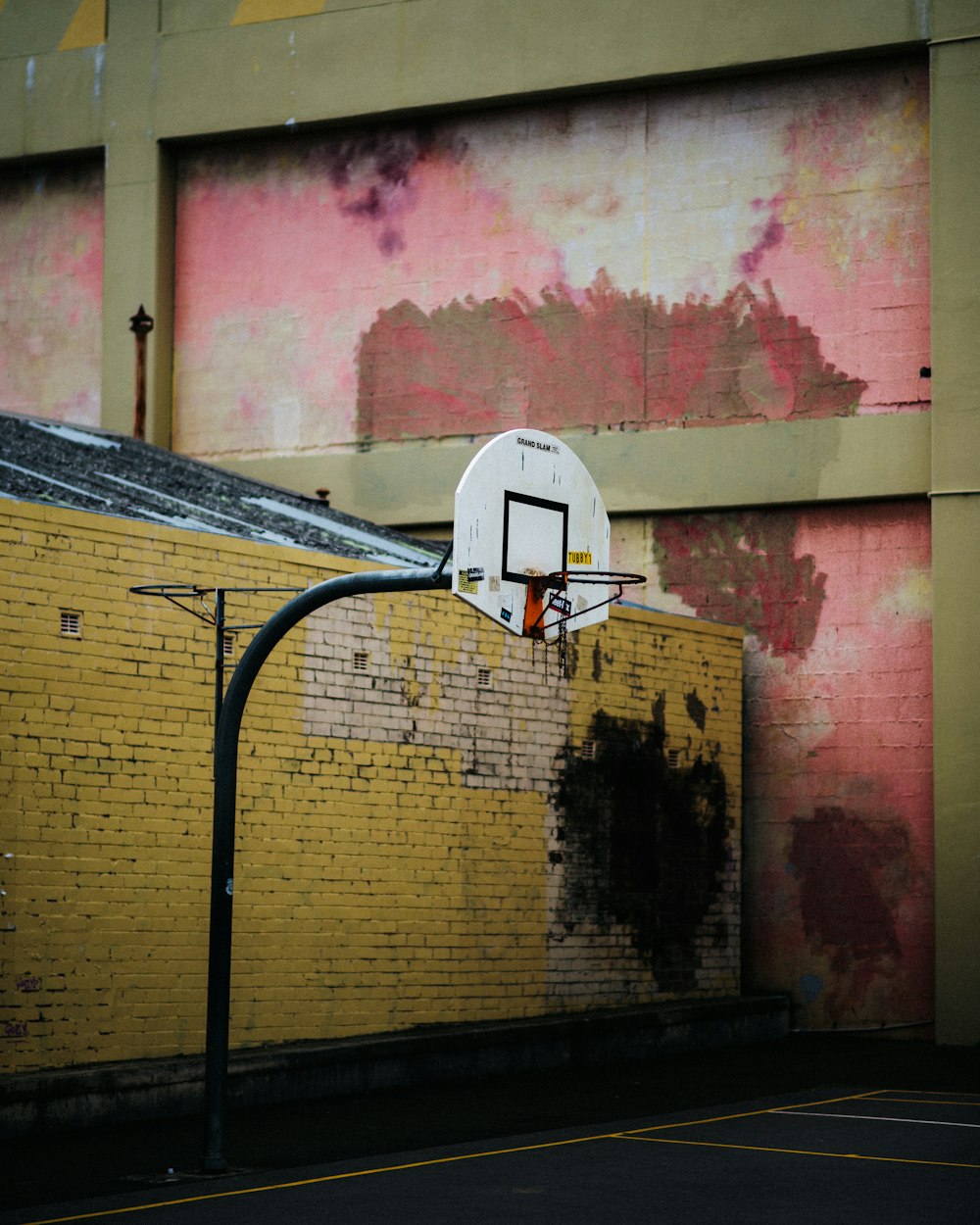 a basketball hoop in front of a brick wall