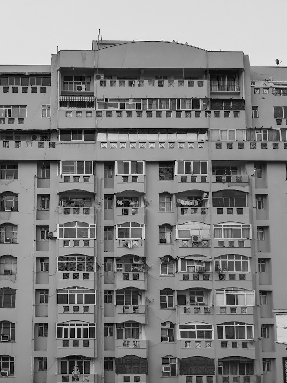 a tall building with lots of windows and balconies