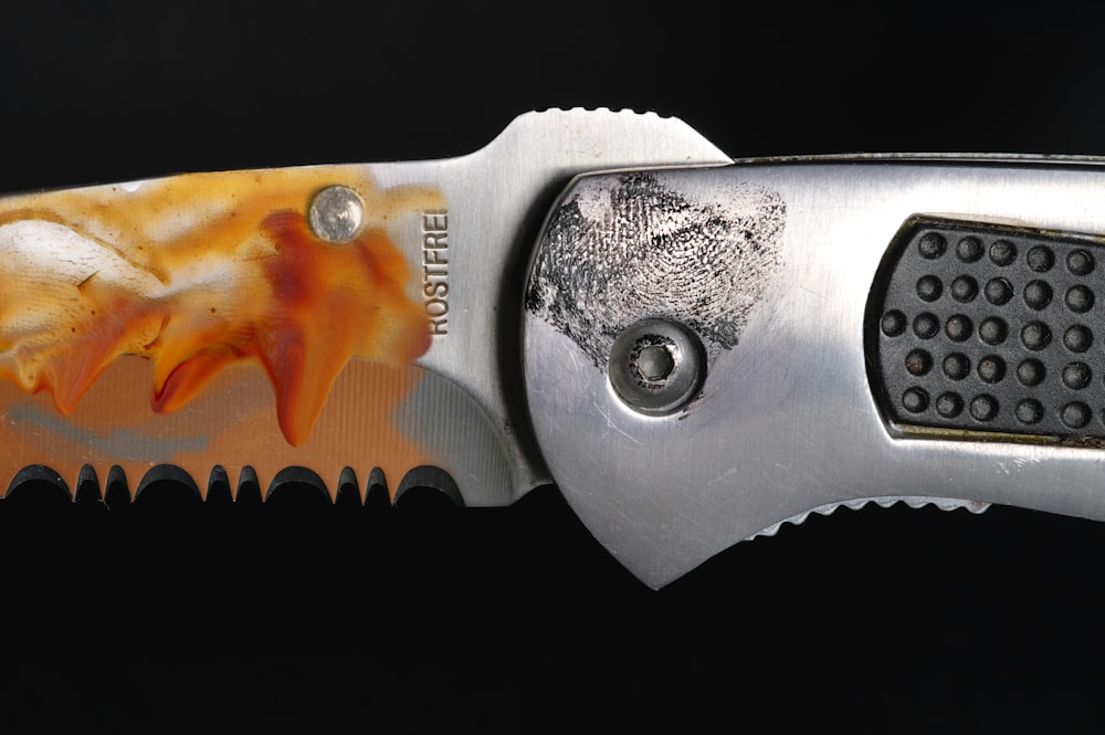 a close up of a knife with a design on it