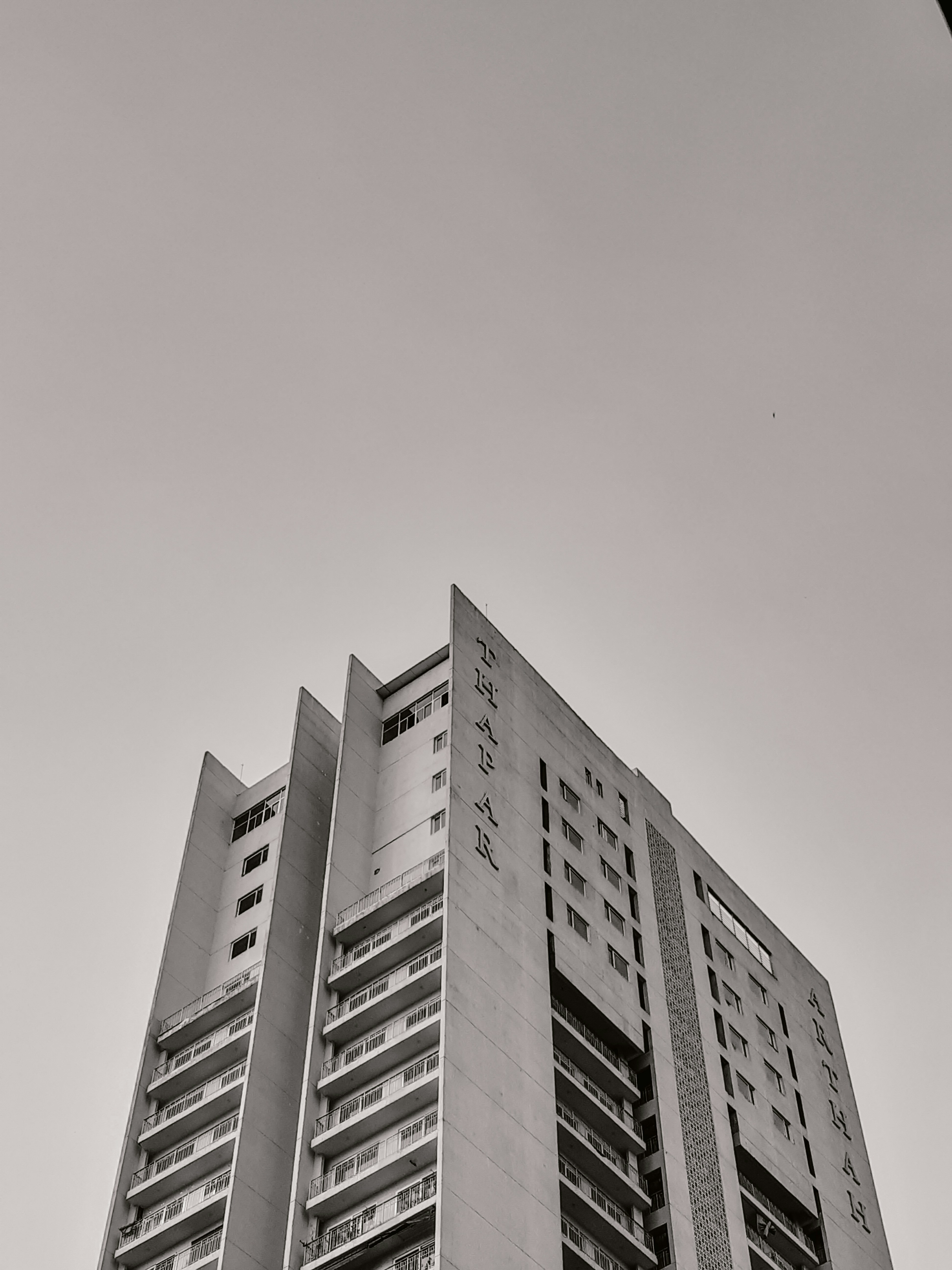 A black and white shot of buildings - apartments.