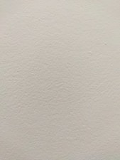 A freshly painted living room wall with a smooth, flawless finish.