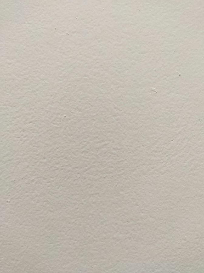 Skim-coated wall after sanding in a Hoboken NJ brownstone, ready for primer