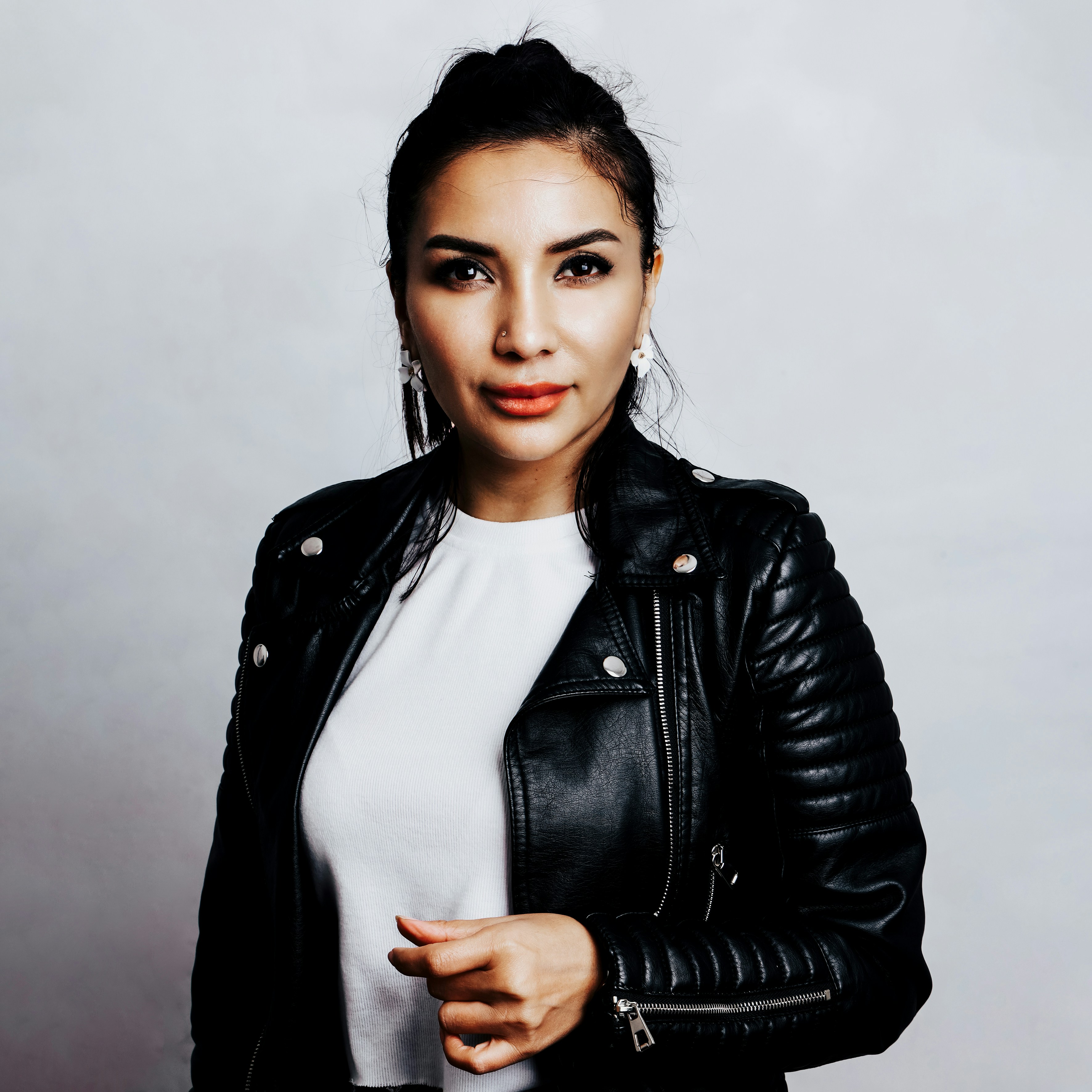 A woman in a black leather jacket posing for a picture photo – Free ...