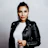 a woman in a black leather jacket posing for a picture