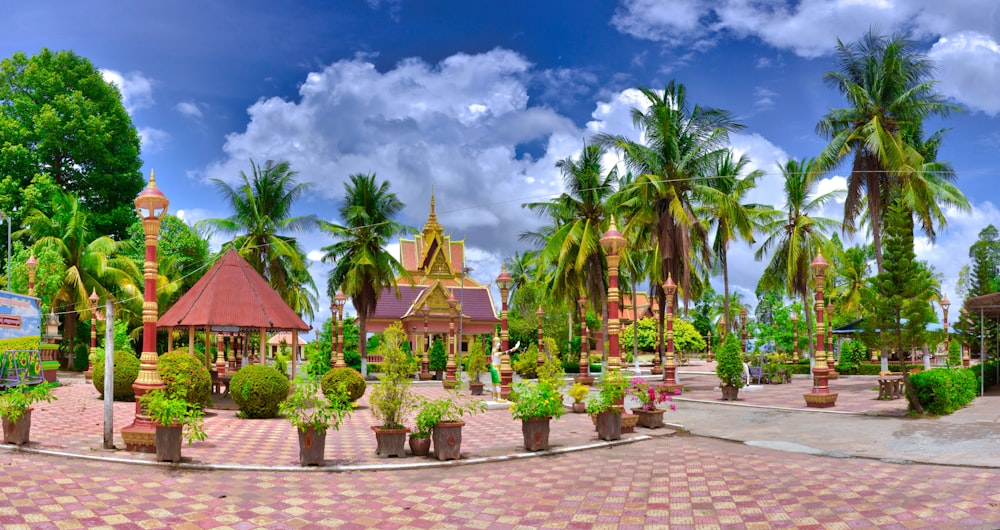 a park with palm trees and a gazebo