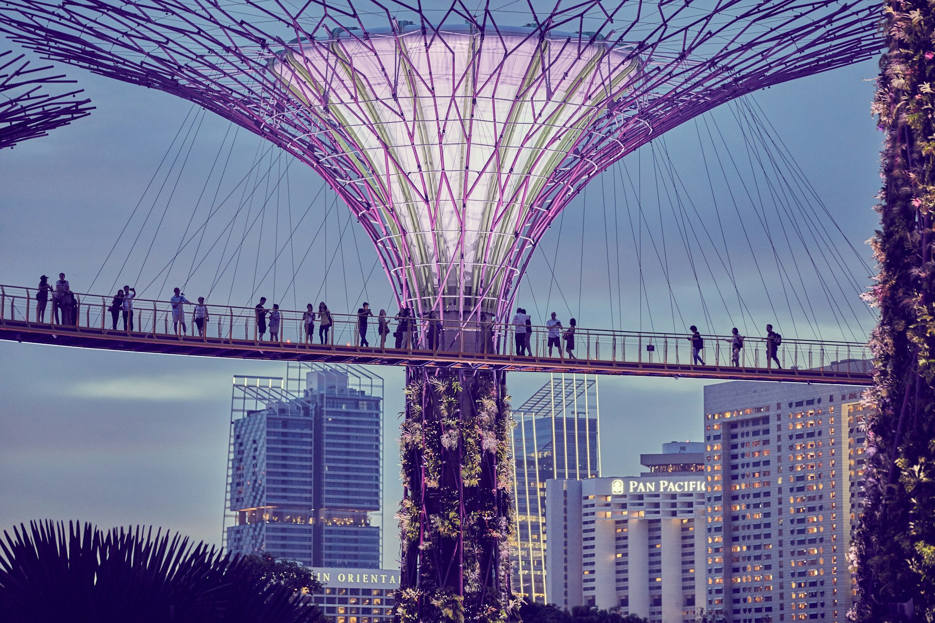 a group of people walking across a bridge