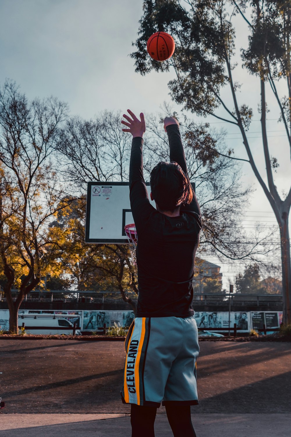 a man in a black shirt is playing basketball