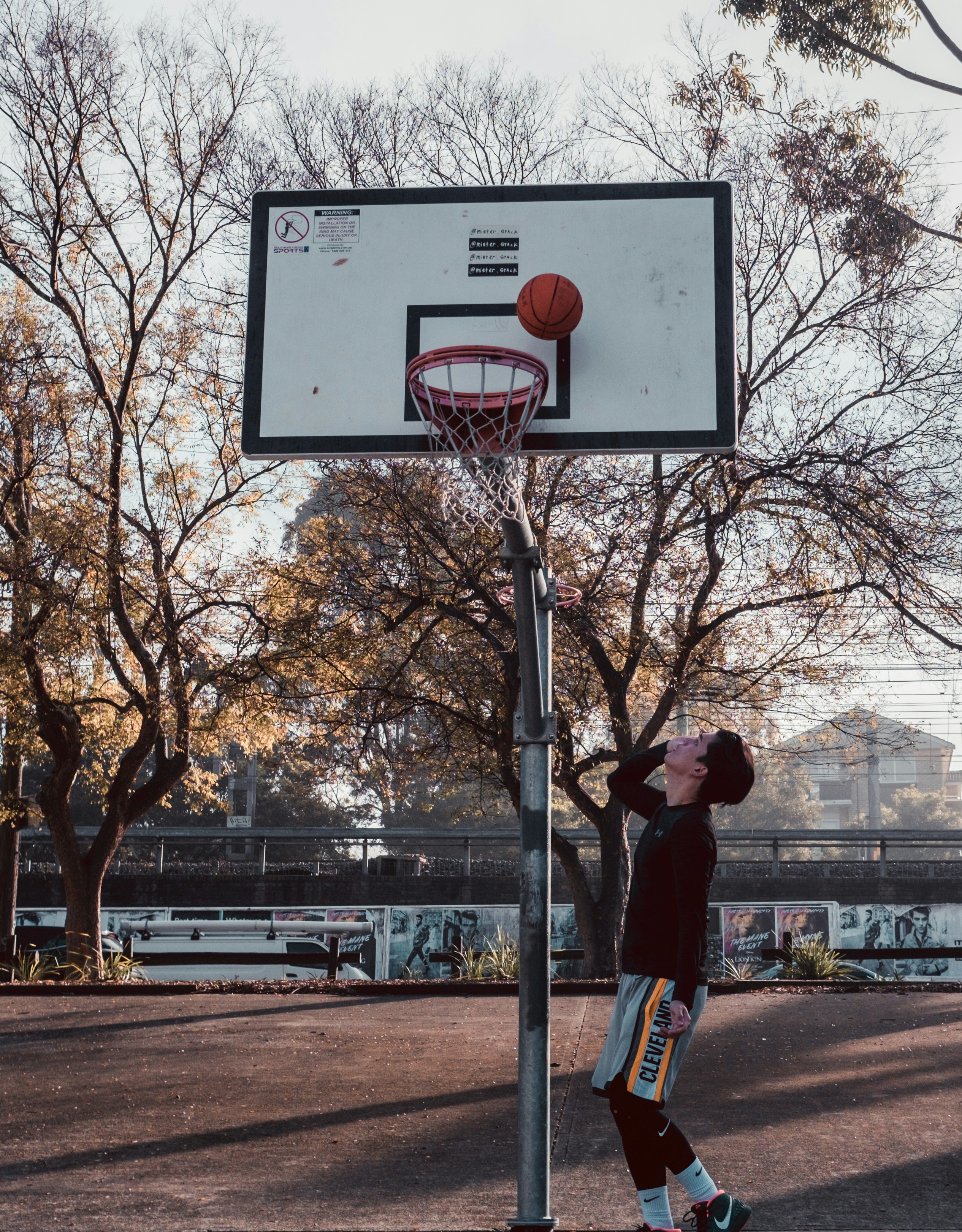 A young man playing basketball on a basketball court photo Free