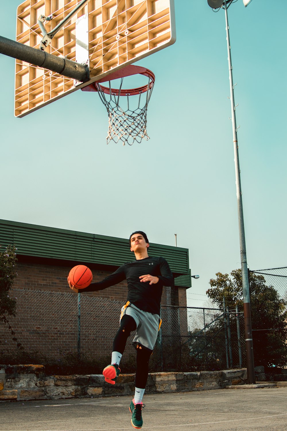 a young man is playing basketball on a court