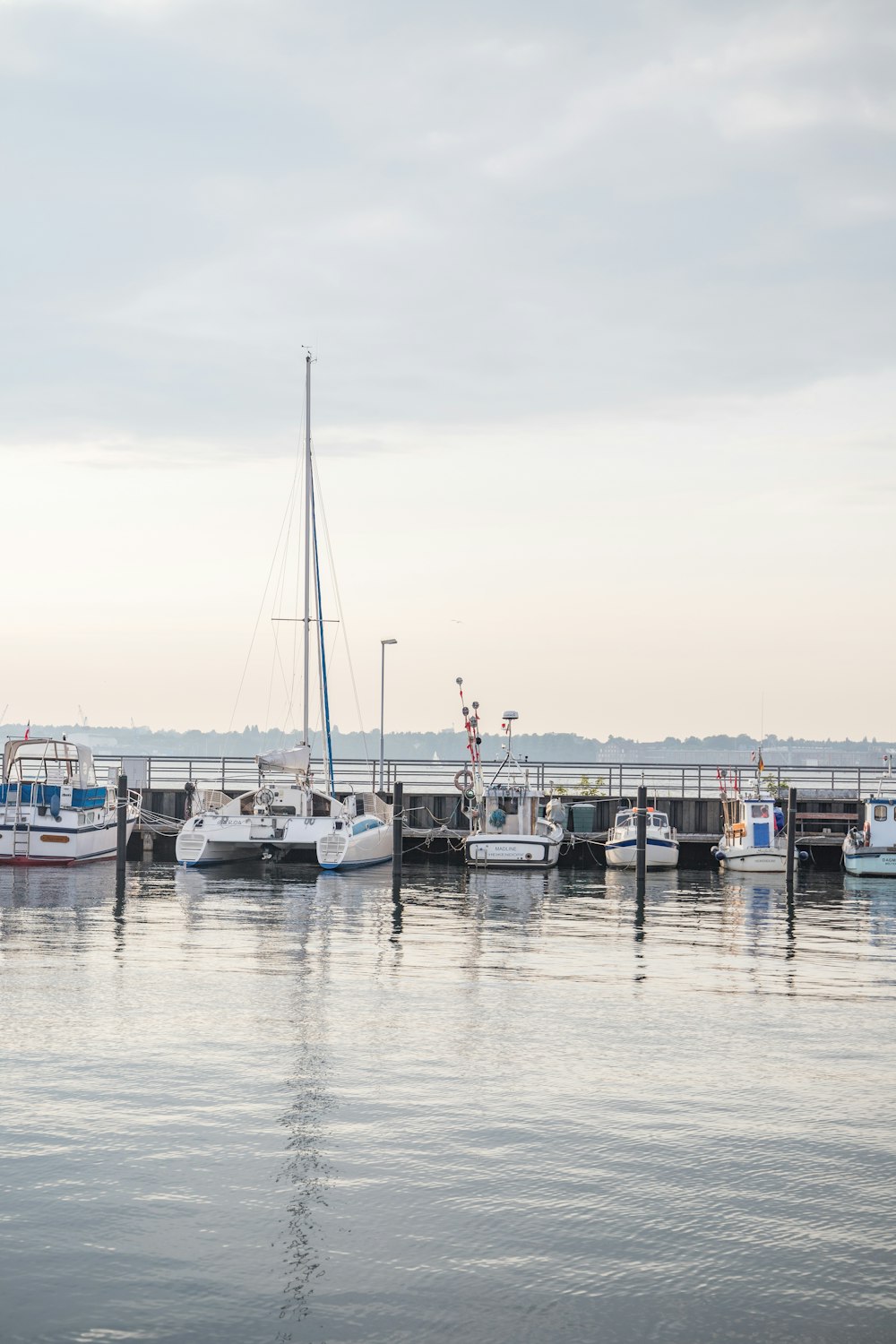 a harbor filled with lots of boats under a cloudy sky