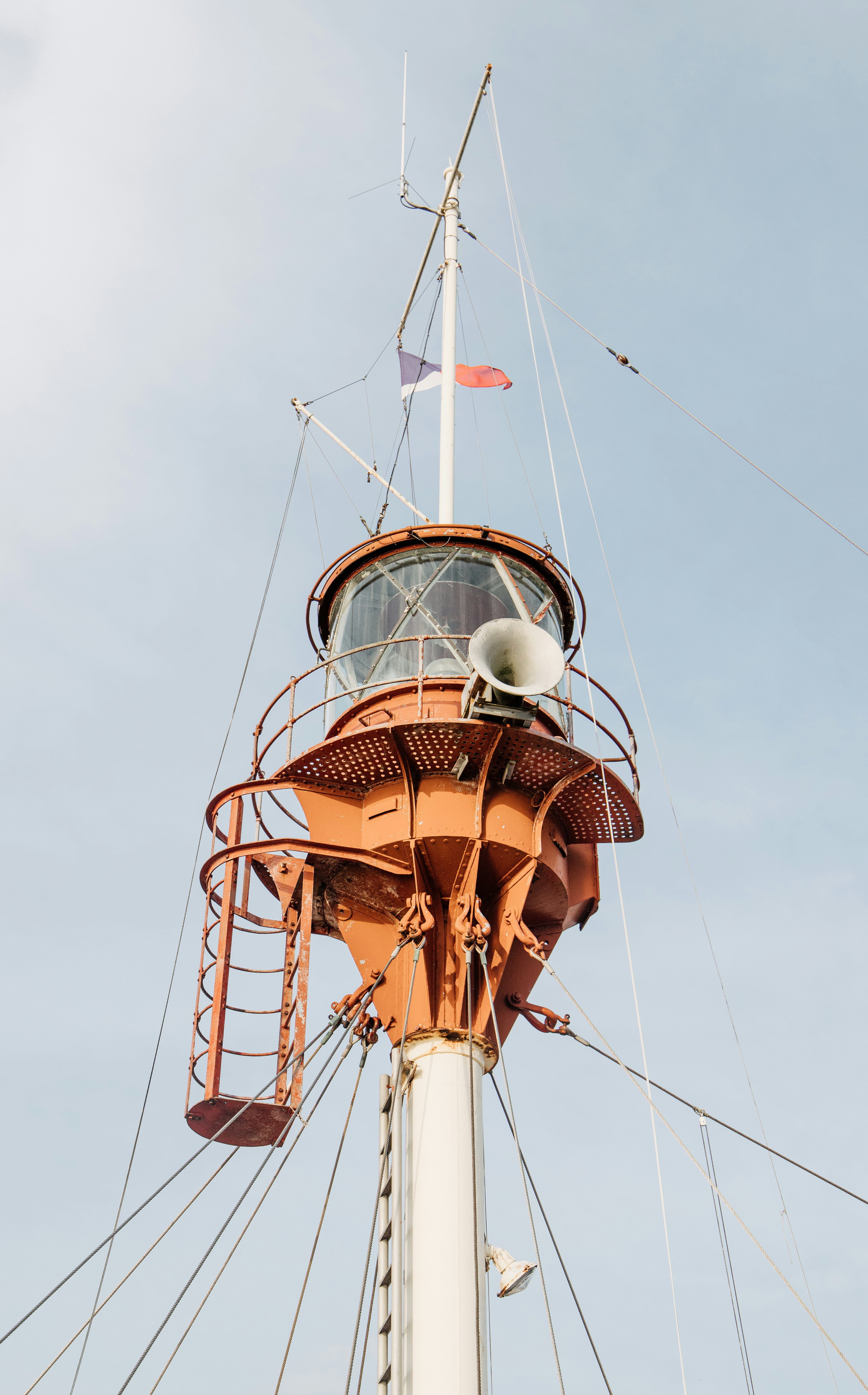 a tall tower with a flag on top of it