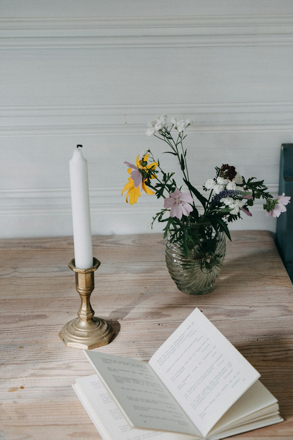 a candle and a book on a table