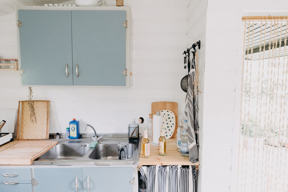 a kitchen with blue cabinets and a sink
