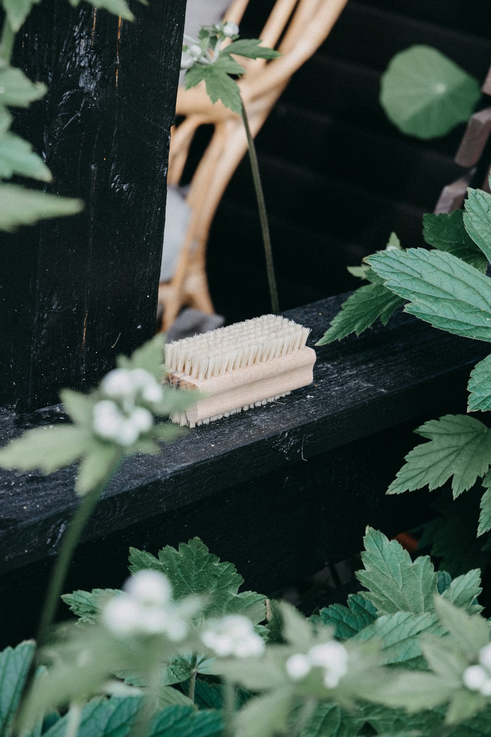 a white brush sitting on top of a wooden bench