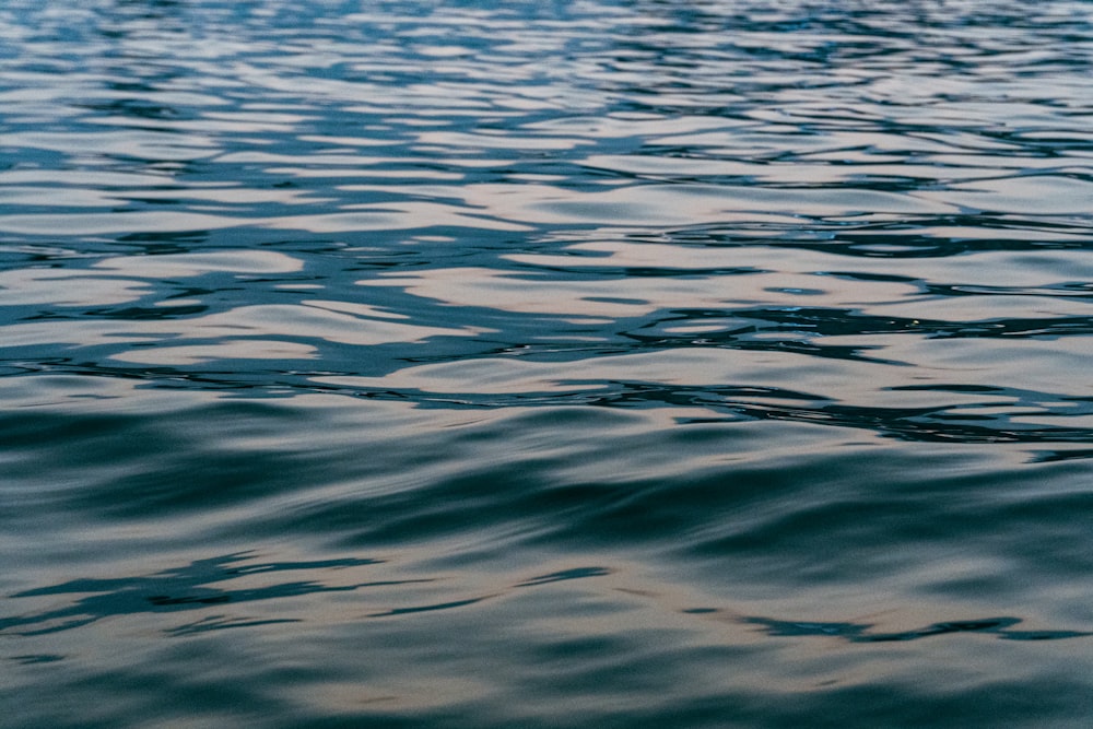 a large body of water with a boat in the distance