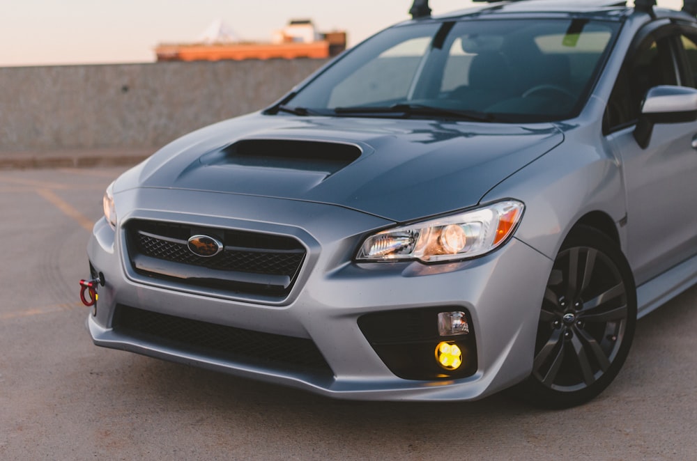 a silver subarunt parked in a parking lot