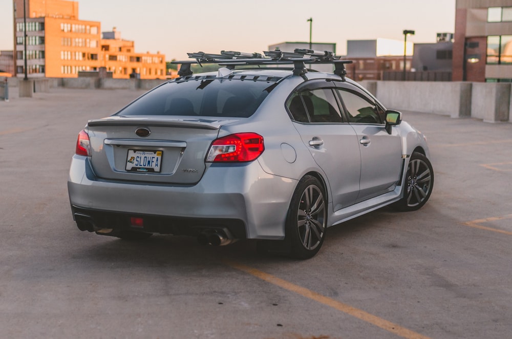 a silver subarunt parked in a parking lot