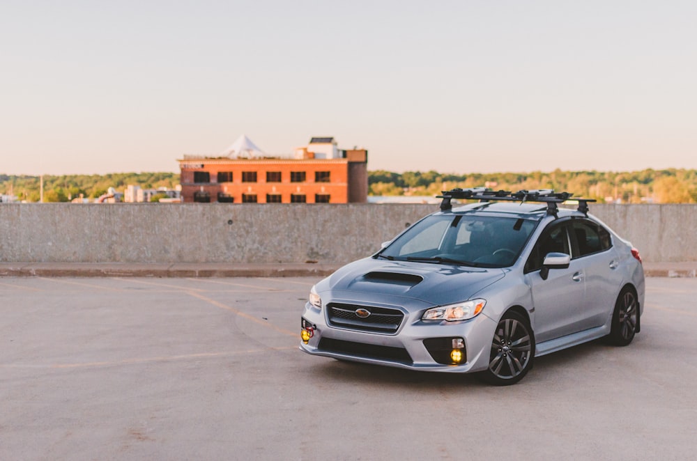 a silver subarunt parked in a parking lot