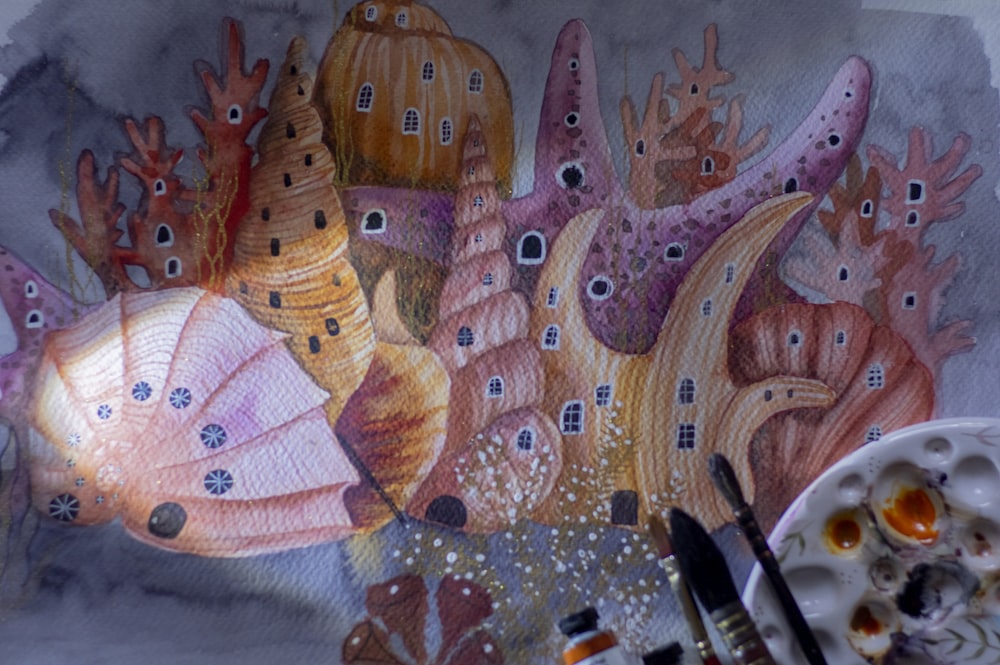 une peinture d’une scène de vie marine avec une palette et un pinceau