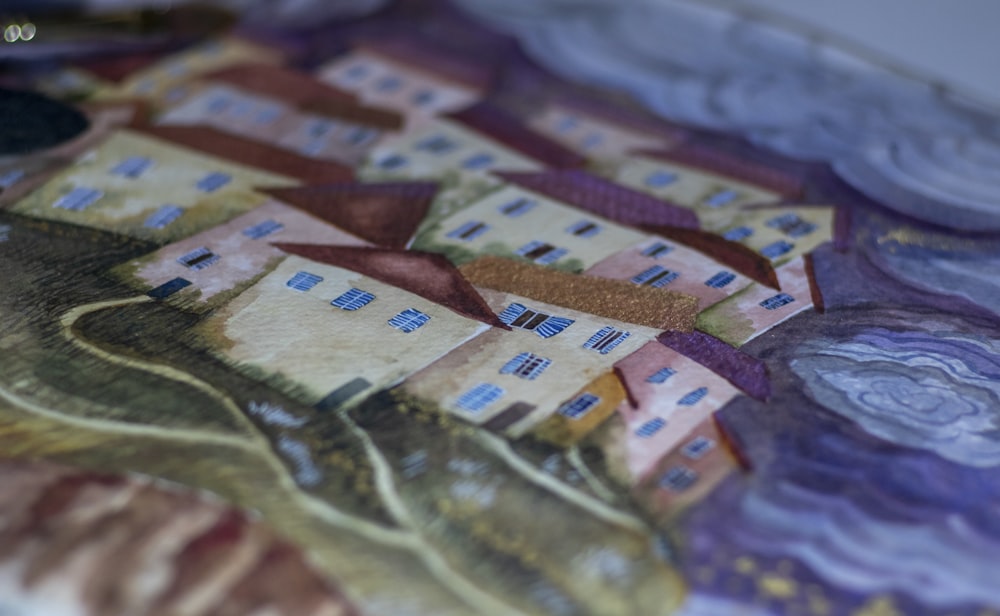 a close up of a quilt with houses on it