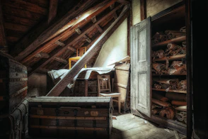 an attic with a bed and a chest of drawers
