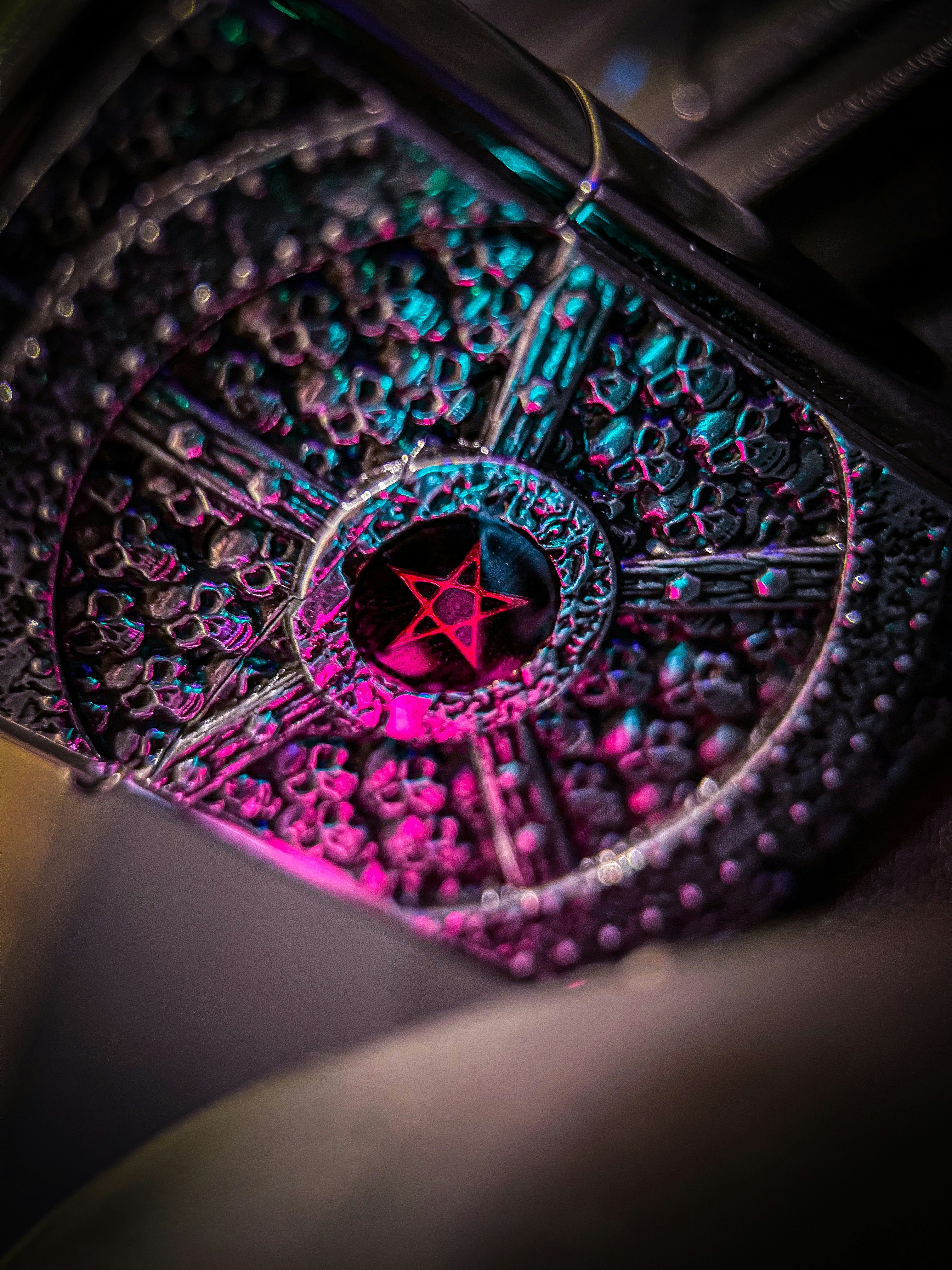 a close up of a metal object with a red star on it