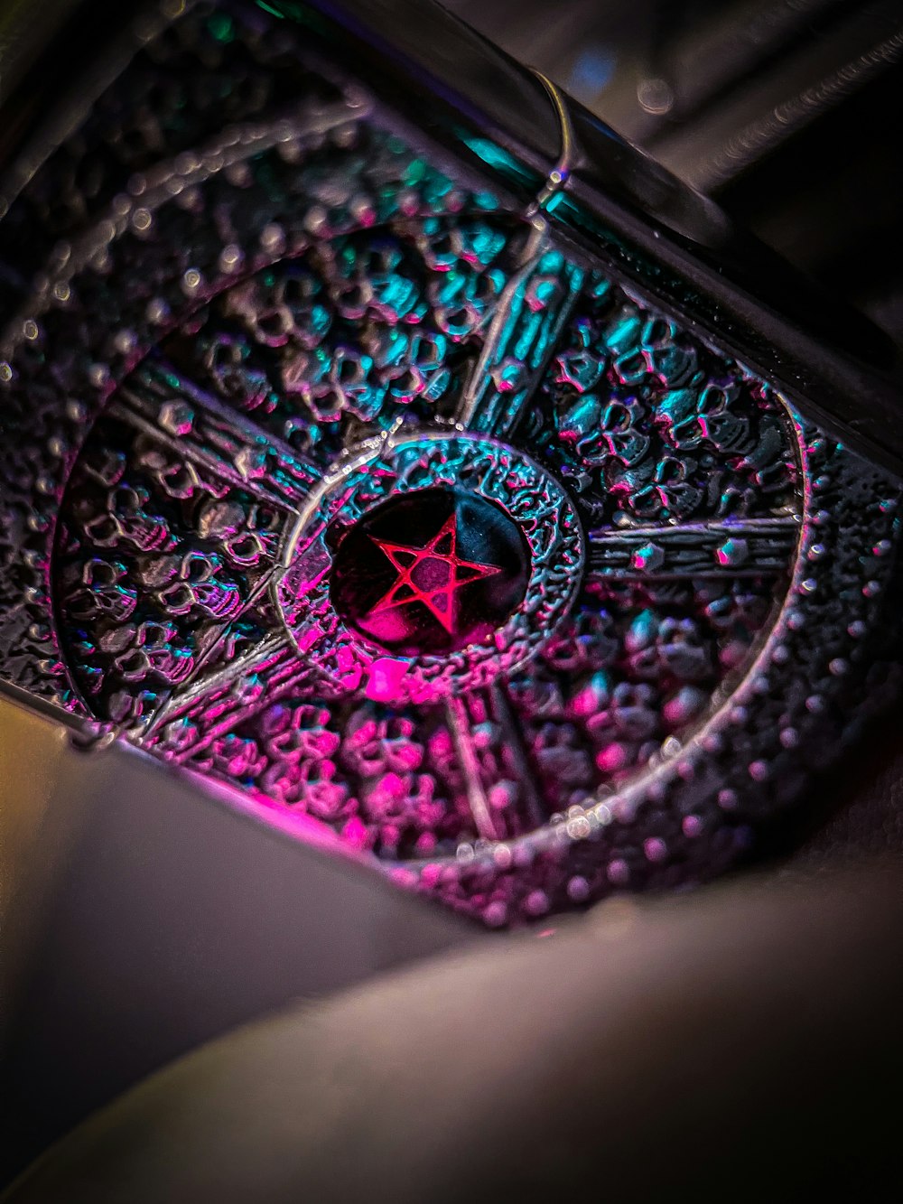 a close up of a metal object with a red star on it