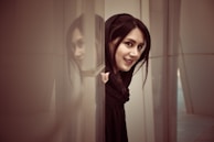 A candid moment of a cam girl teasing the camera with a mischievous grin.