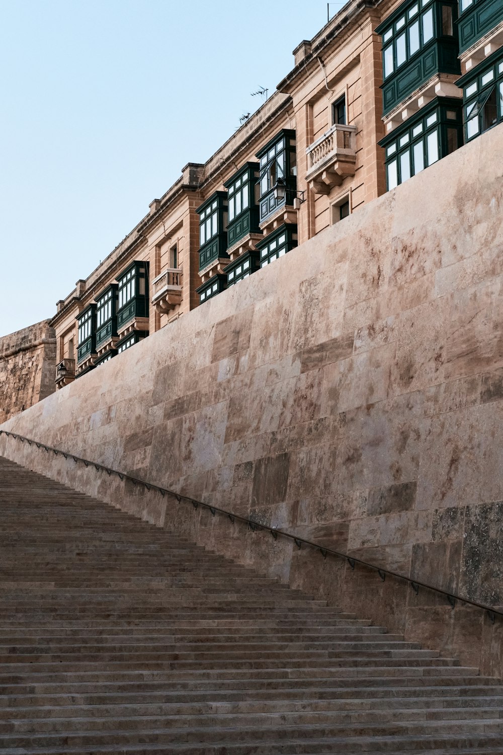 a stone wall with steps leading up to a building