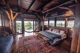 a bedroom with a hammock hanging from the ceiling