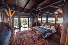a bedroom with a hammock hanging from the ceiling