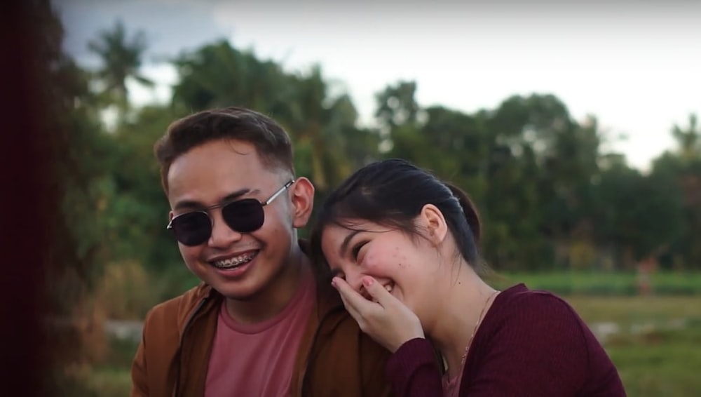 a man and a woman sitting next to each other