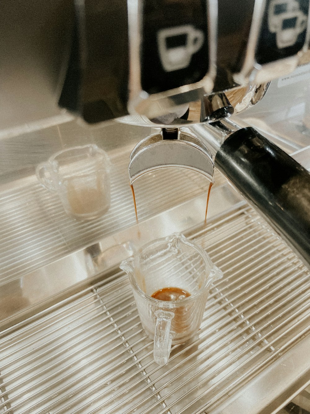 a cup of coffee being poured into a glass