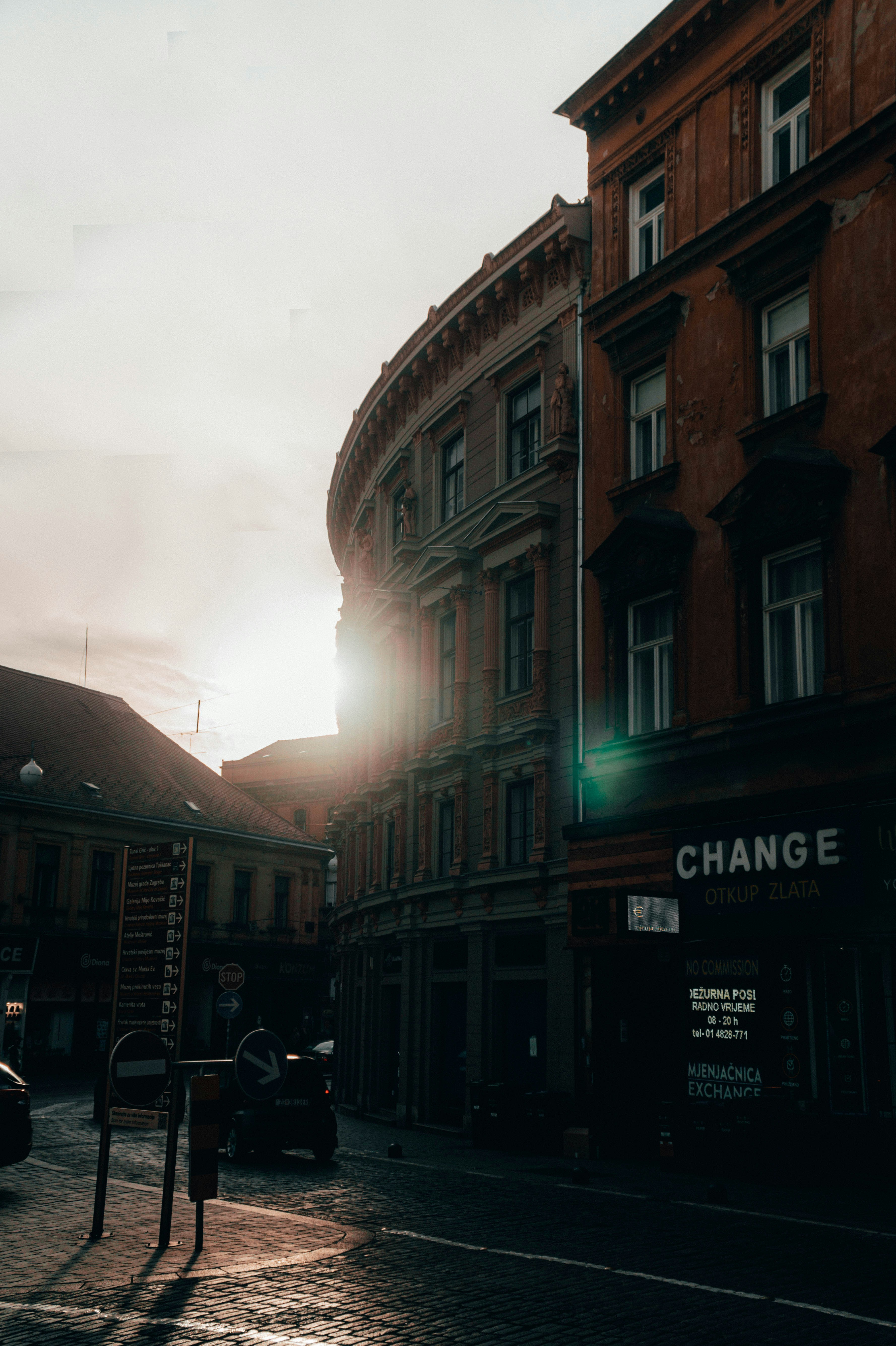 a city street with cars parked on the side of it