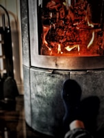 A family enjoying a cozy evening by the fireplace with heating vents visible.