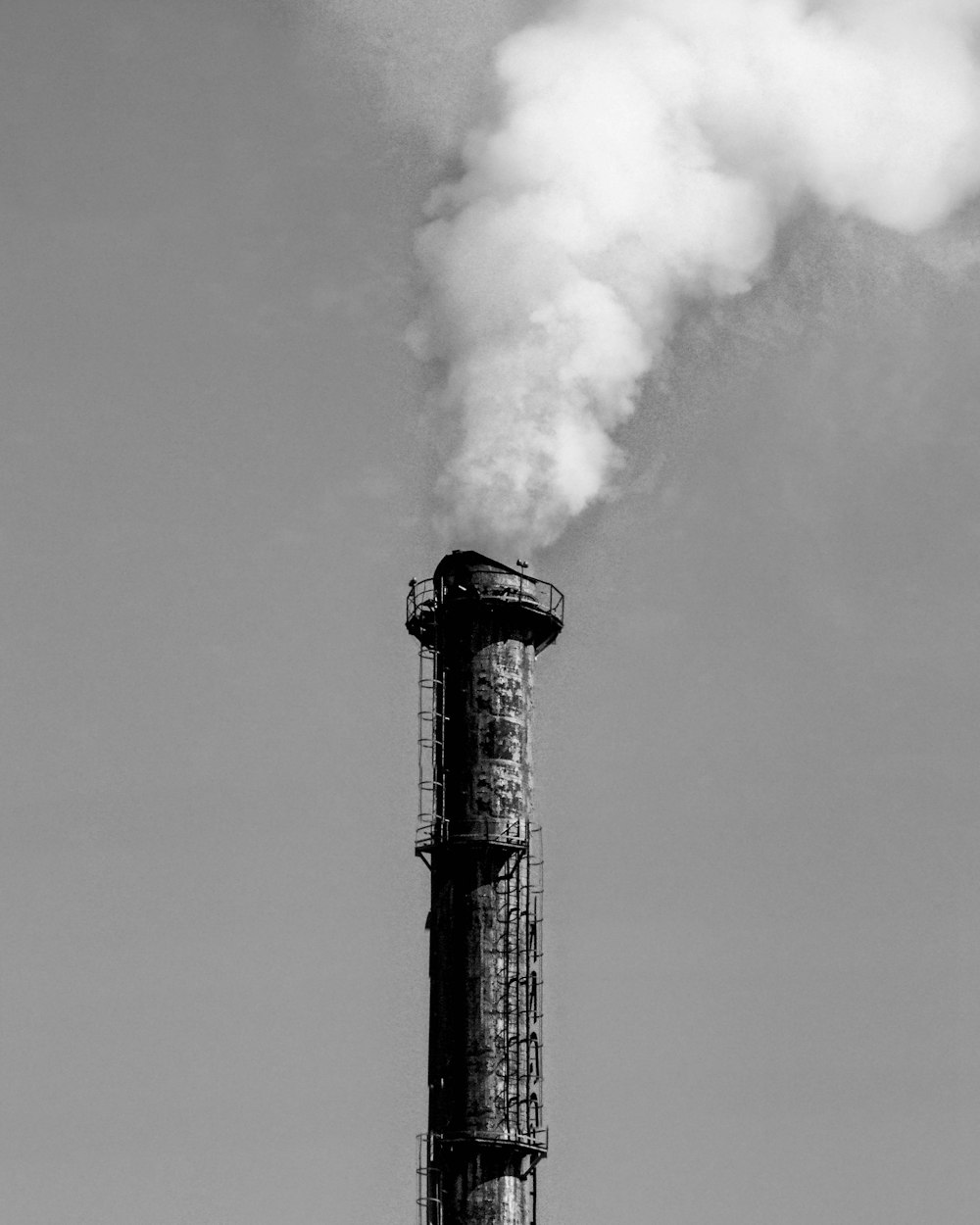 a smokestack emits from the top of a building