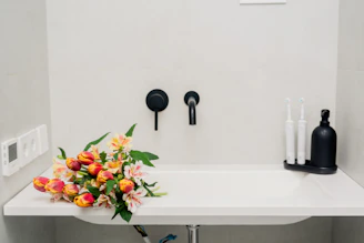 a bathroom sink with a bunch of flowers on it